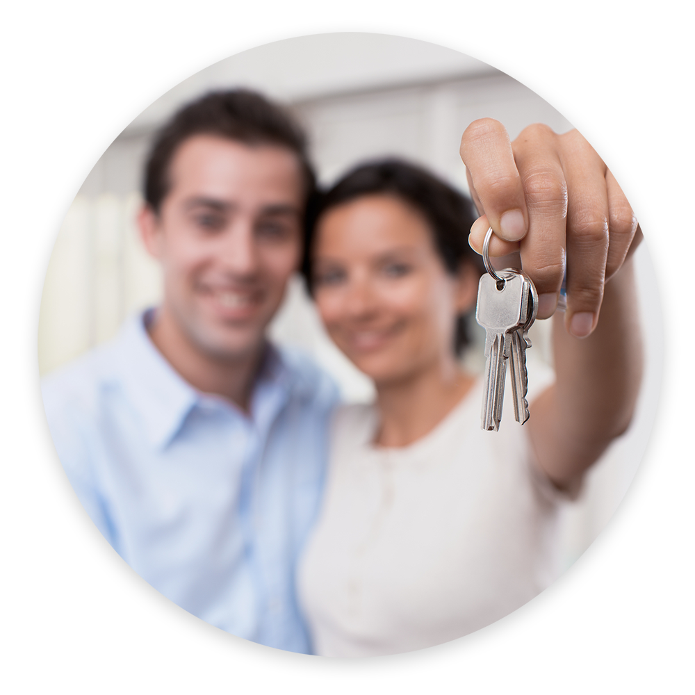 Couple holding new house keys after a home inspection 