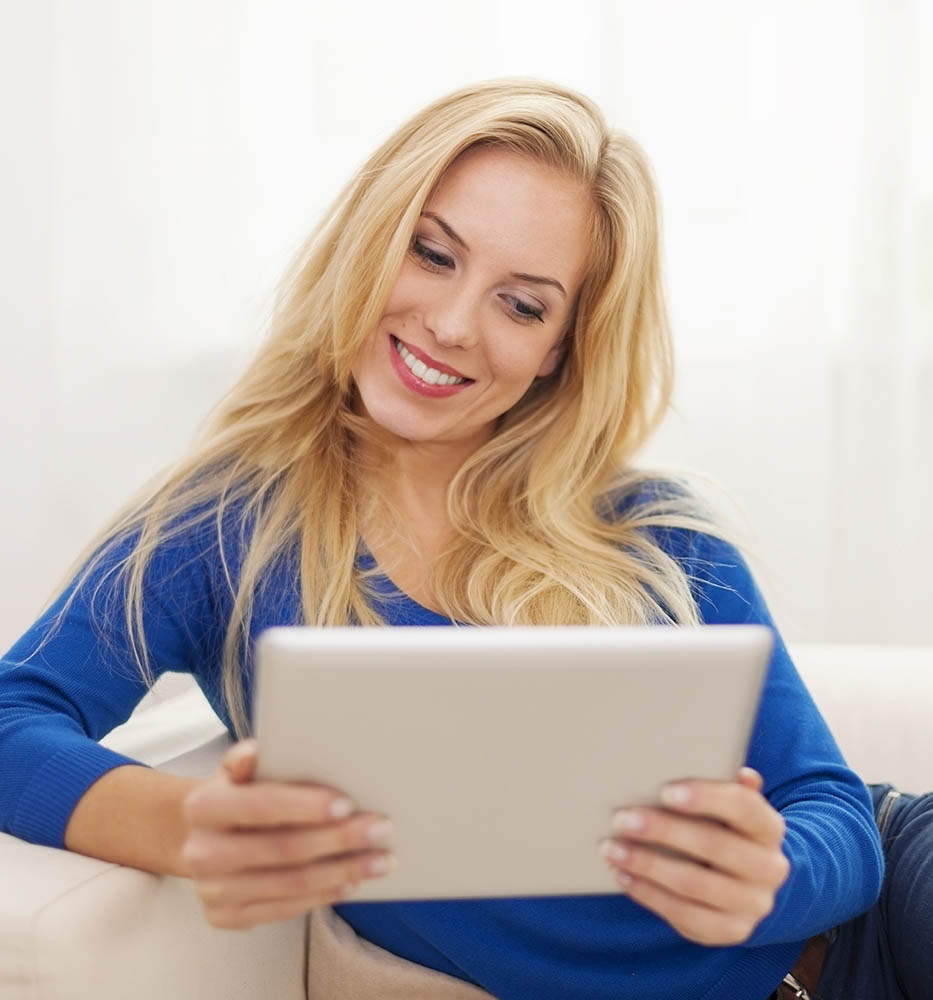 Woman using a tablet to view her online home inspection report 